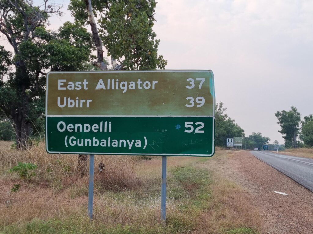 A photograph of a road sign in the Northern Territory featuring a town named East Alligator