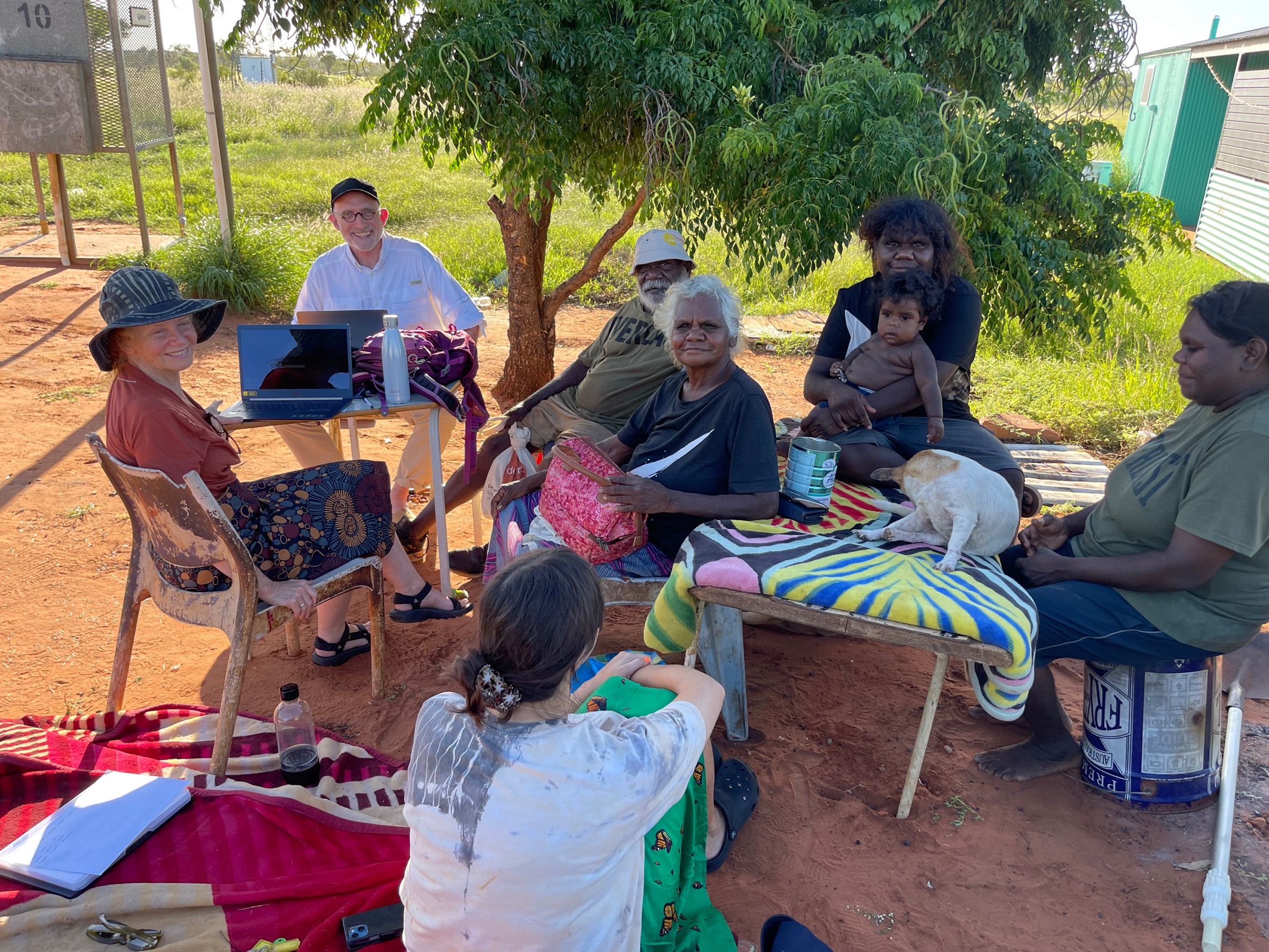 Arts Law's former CEO Robyn Ayres and volunteer solicitor Shane Simpson working with a group of Aboriginal artists outside.
