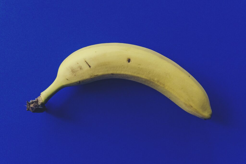 Image of a yellow banana against a blue background.